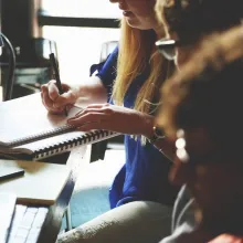 People discussing and writing at the table